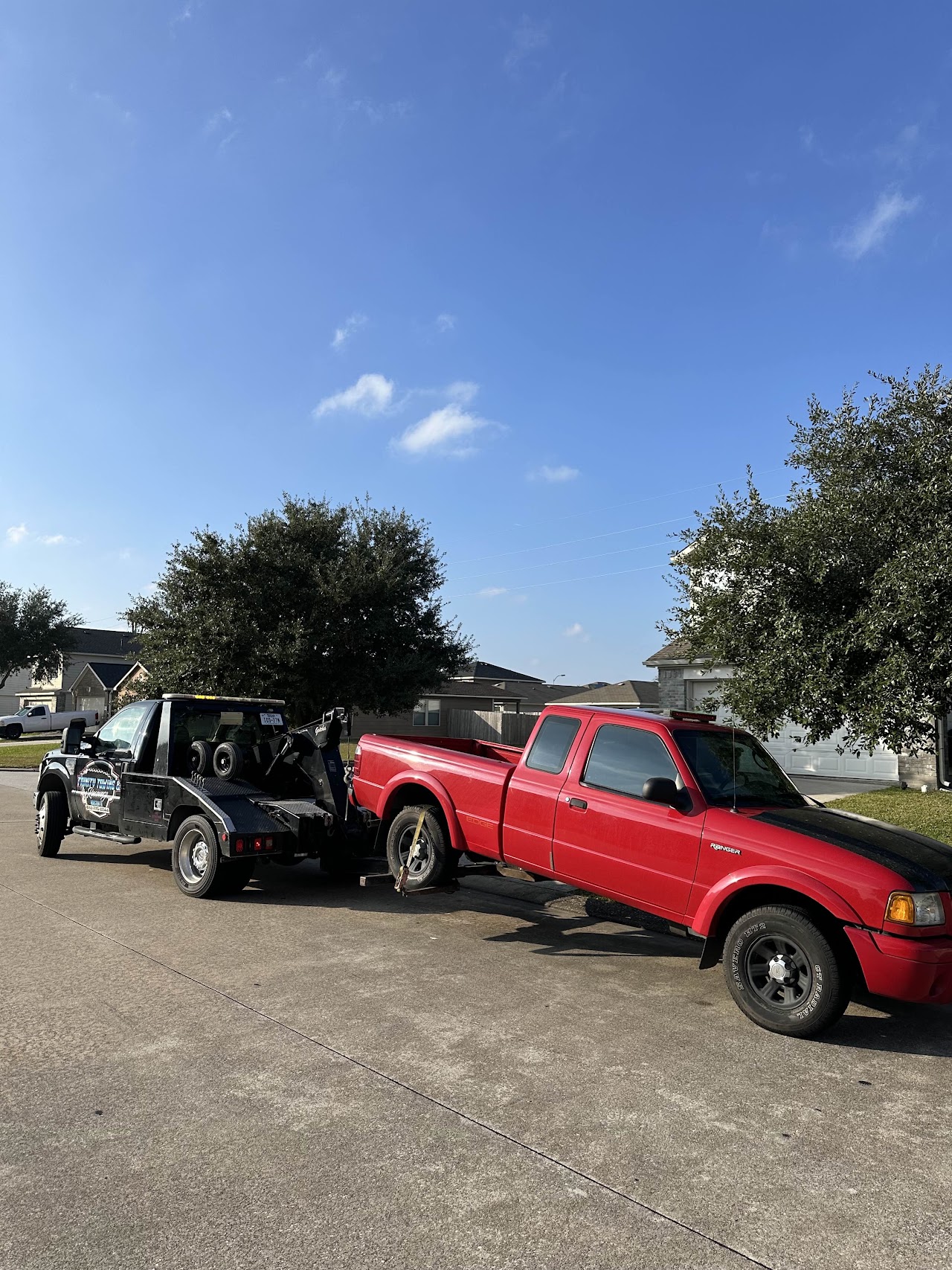 Red Ford Ranger with its rear wheels supported by our wheel-lift